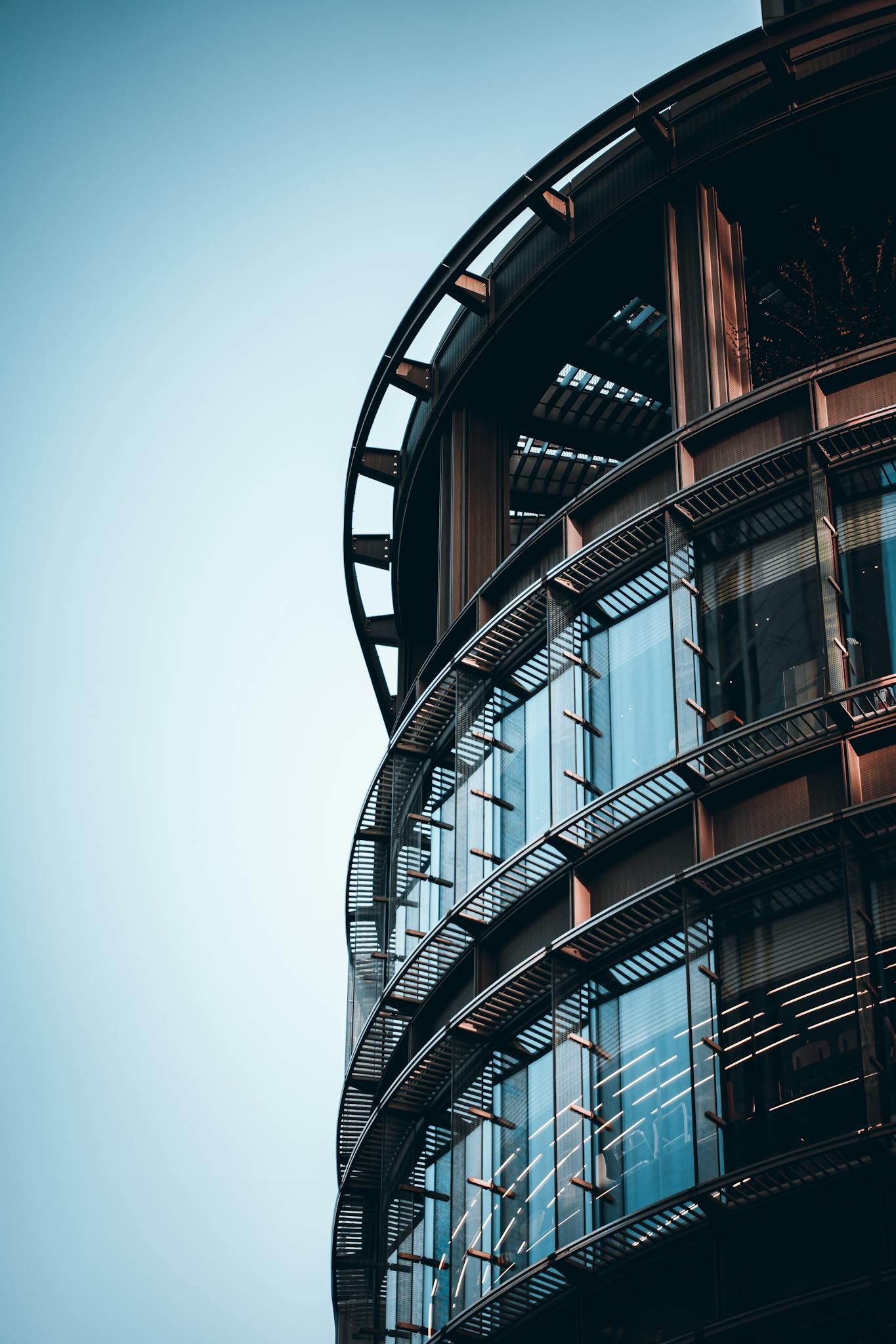 A sleek modern building in Tokyo with a striking glass facade and metallic details.